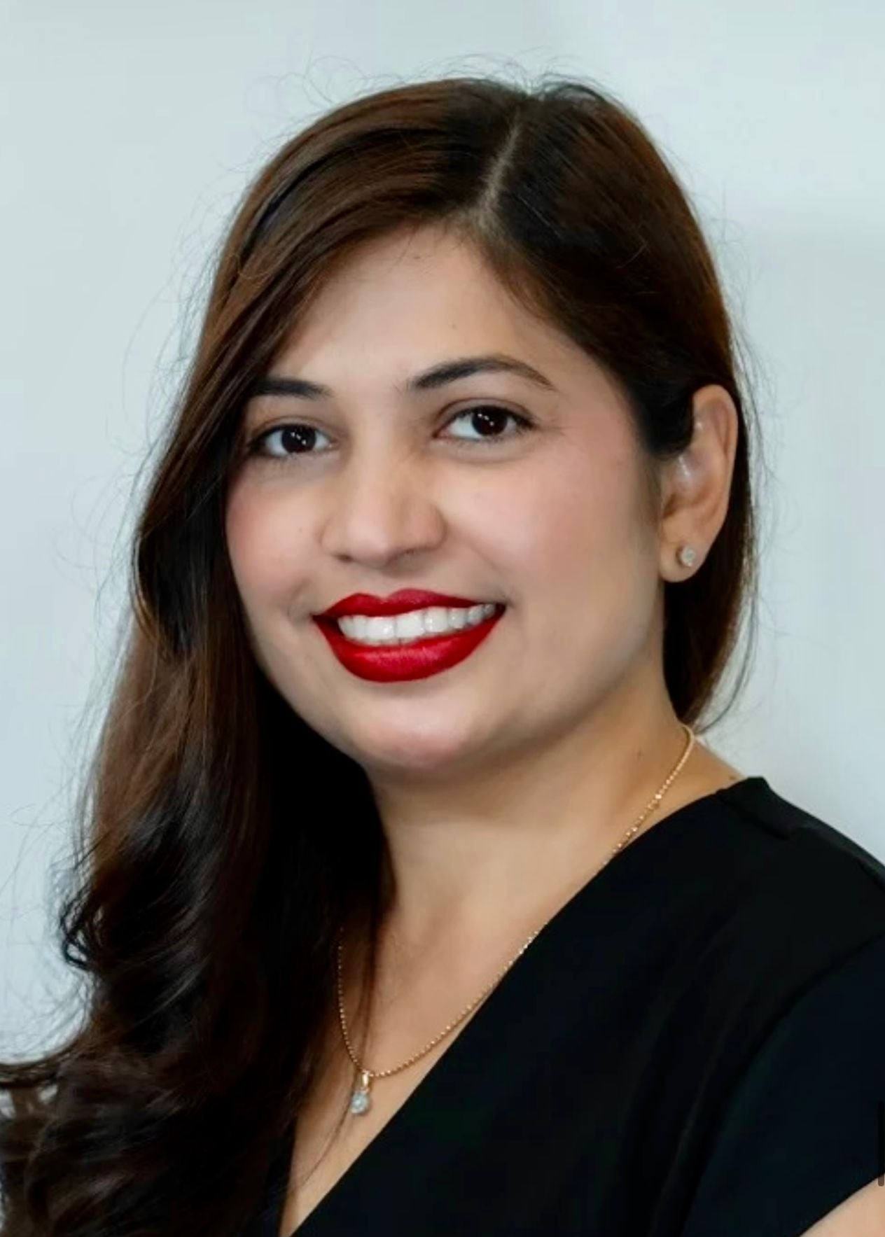 Bijal, founder of Bijal Beauty Salon, smiling in the salon with a passion for cruelty-free and vegan beauty services