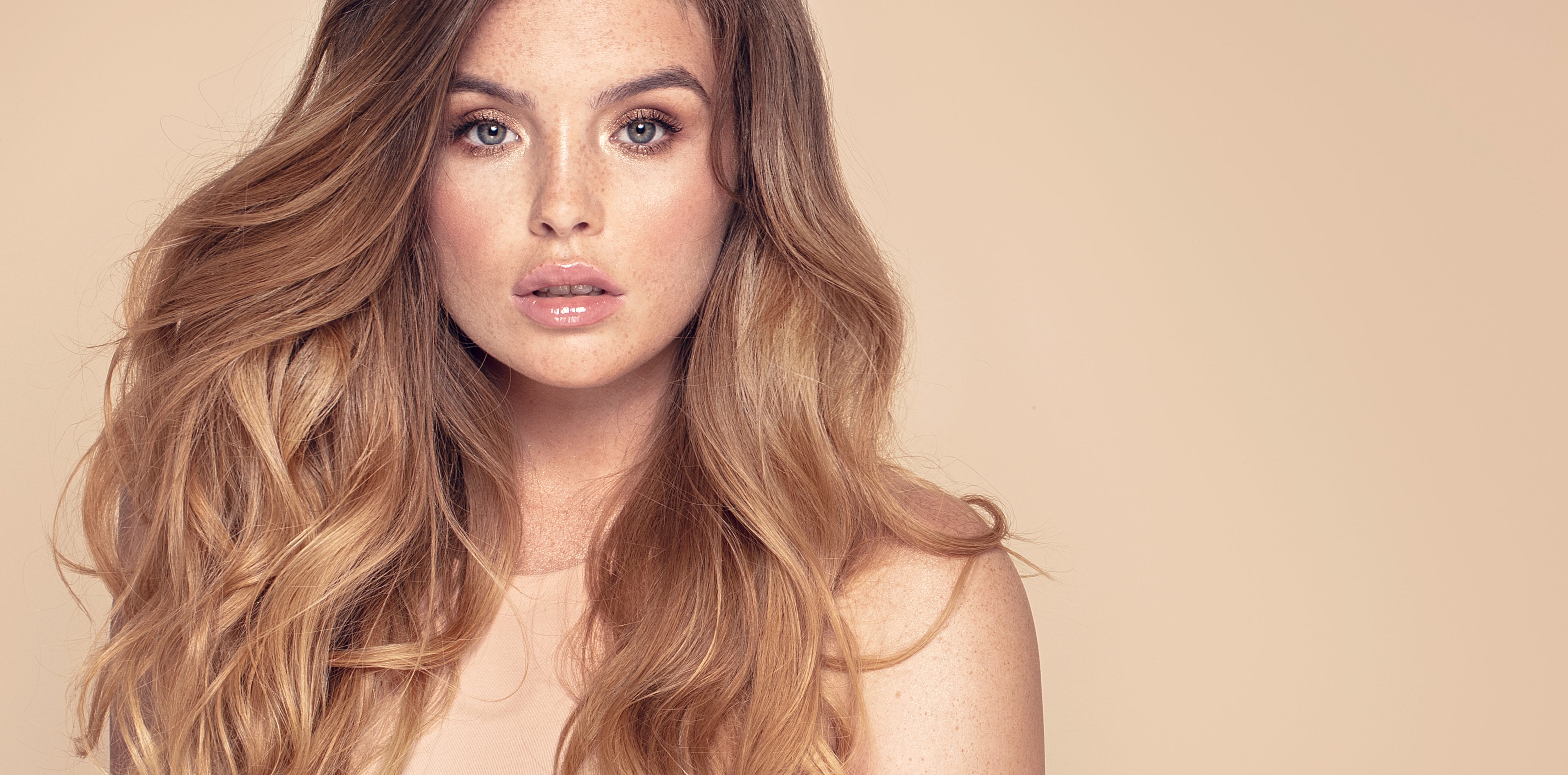 Model with long, styled hair showcasing vegan hair coloring by Bijal Beauty Salon in Riverview, FL