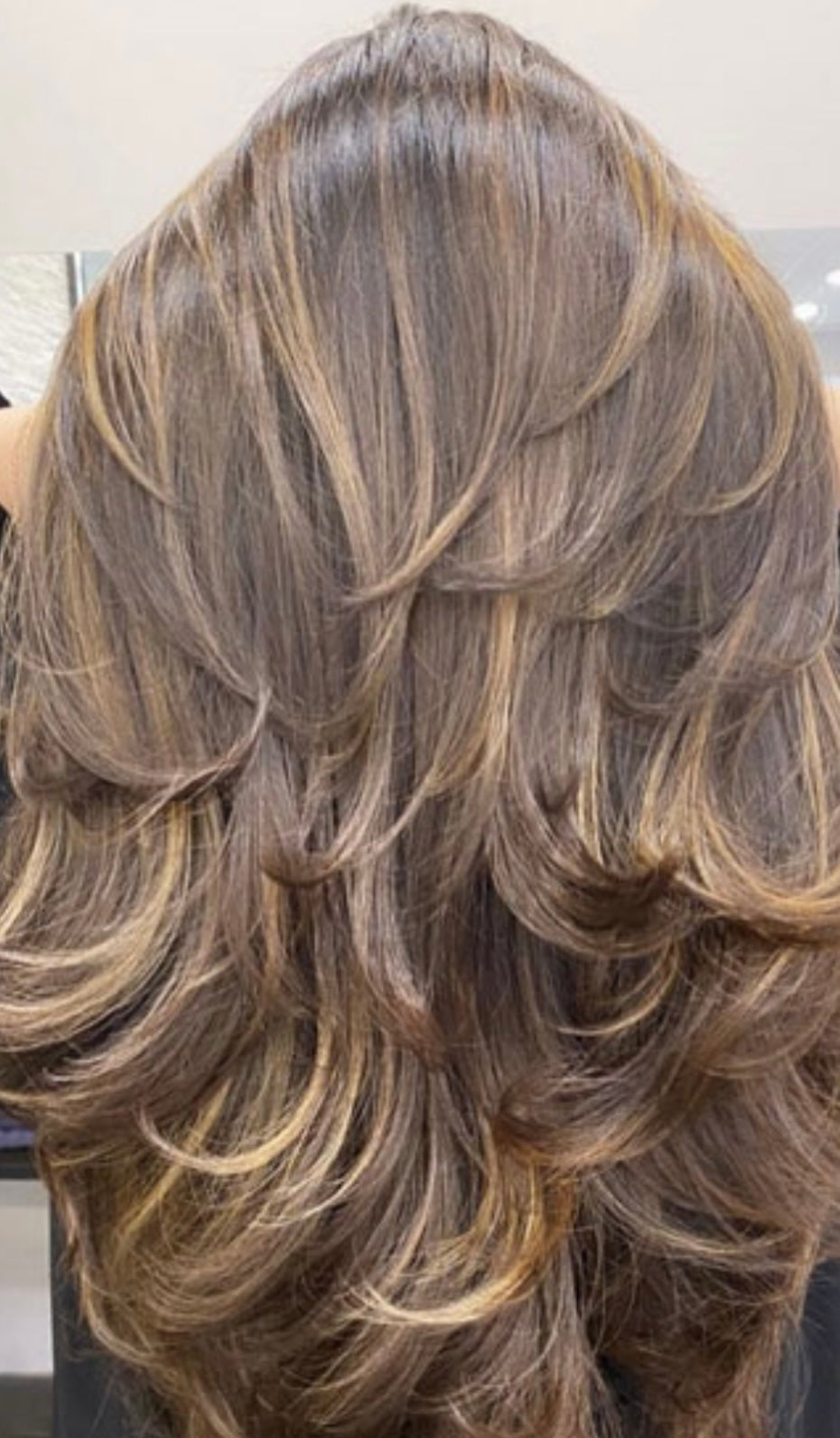 Soft blonde highlights on shoulder-length hair using vegan coloring techniques
