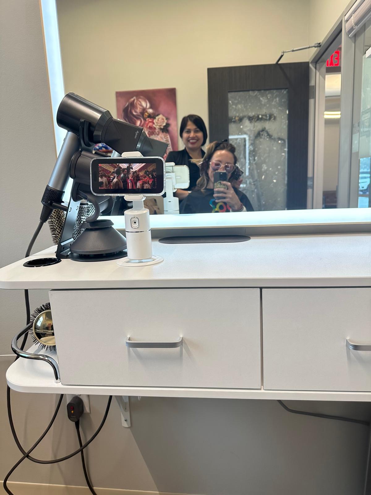 Happy client at Bijal Beauty Salon after a vegan hair service, smiling with styled hair